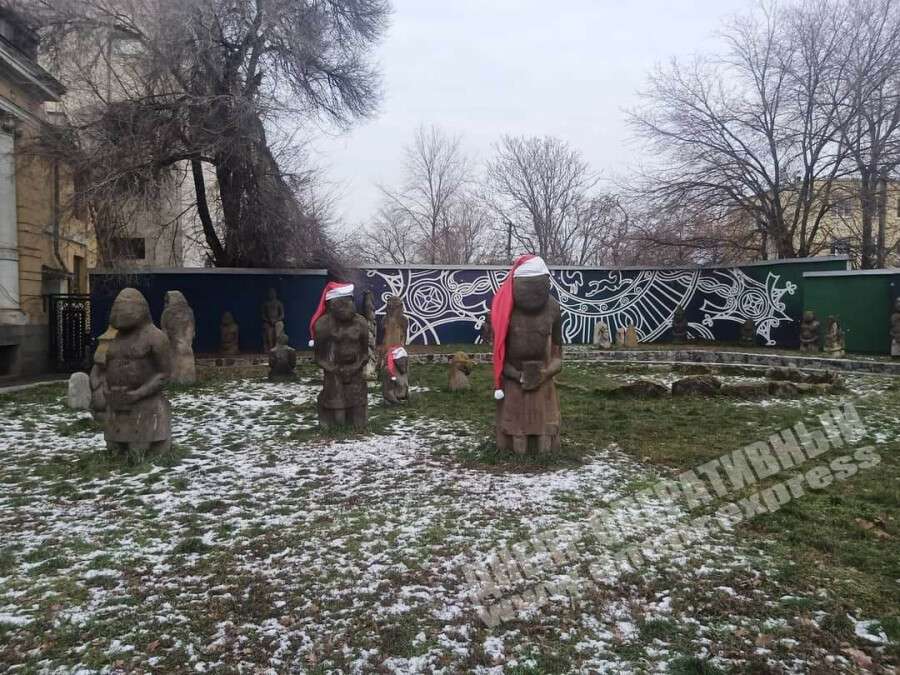 В Днепре возле исторического музея женщина сорвала новогодние шапки с каменных баб
